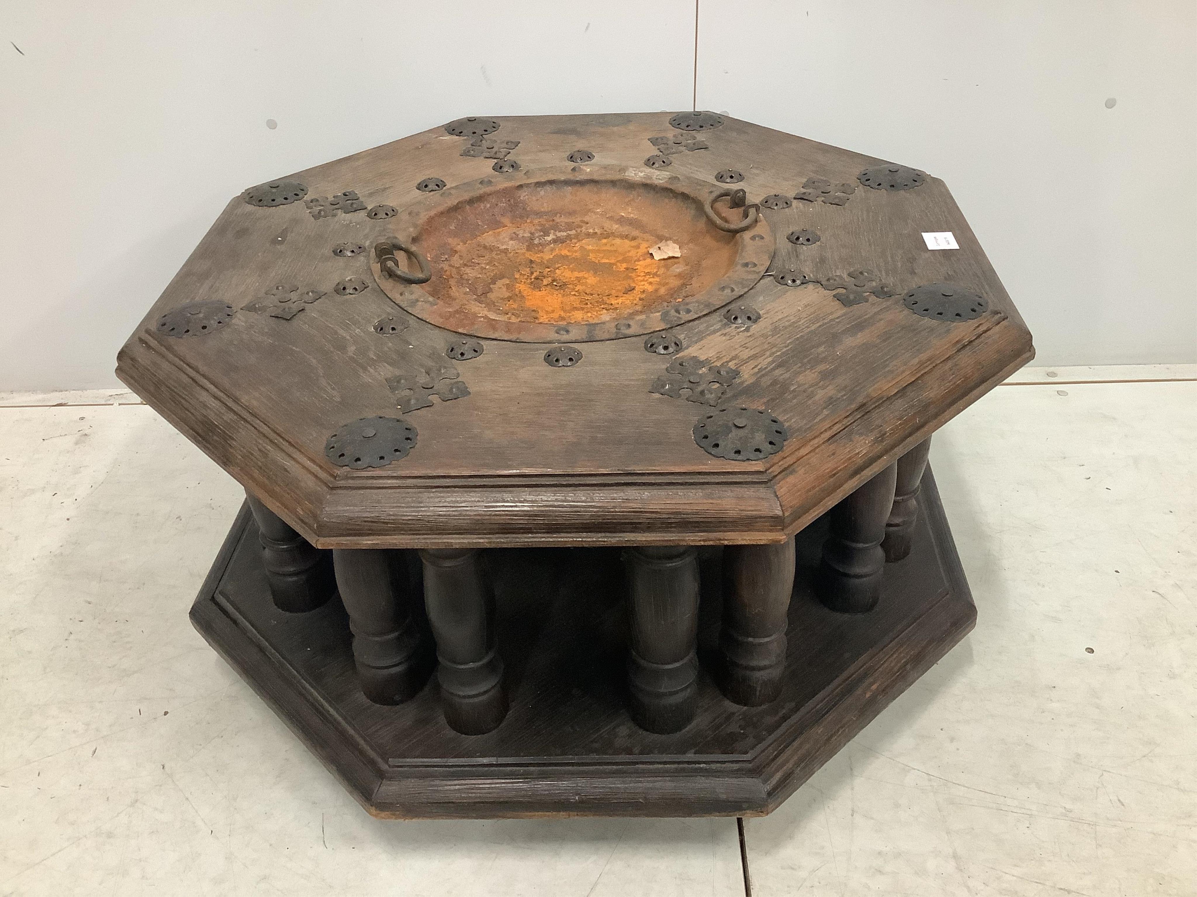 An Indian iron mounted octagonal hardwood brazier table, width 92cm, height 48cm. Condition - poor